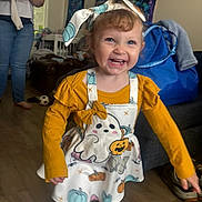Cerenity joined the competition — help win amazing prizes! toddler, child, smiling, happy, indoor, barefoot, yellow_shirt, dress, headband, halloween, ghost, pumpkin, floor, toy, furniture, person, living_room, curtains, bag, jeans