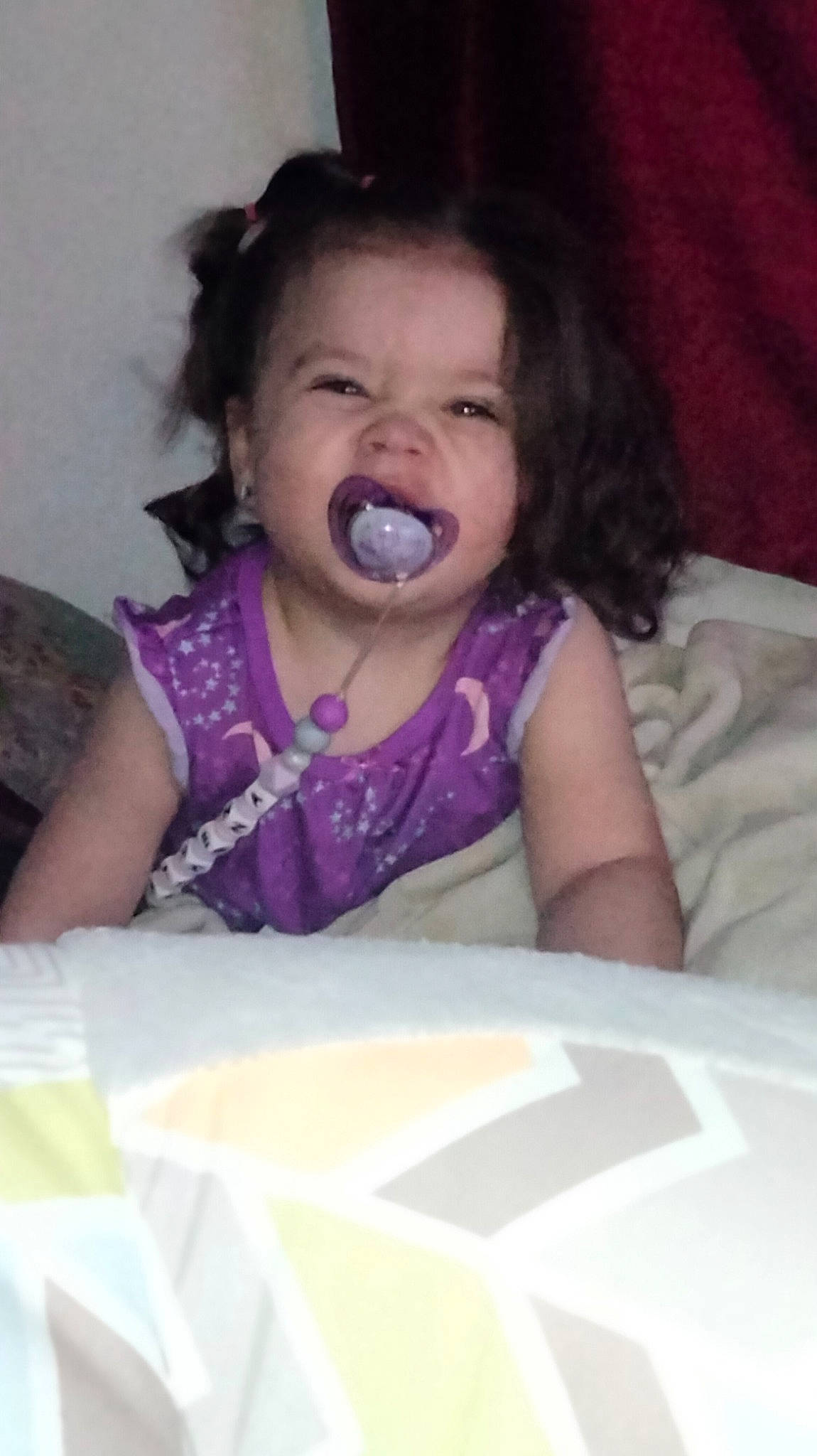 Athena is registered to the contest to win money with this photo: arm, baby_toddler_clothing, cheek, comfort, facial_expression, finger, gesture, hairstyle, hand, happy, human_body, iris, lip, mouth, nose, person, pink, purple, skin, textile