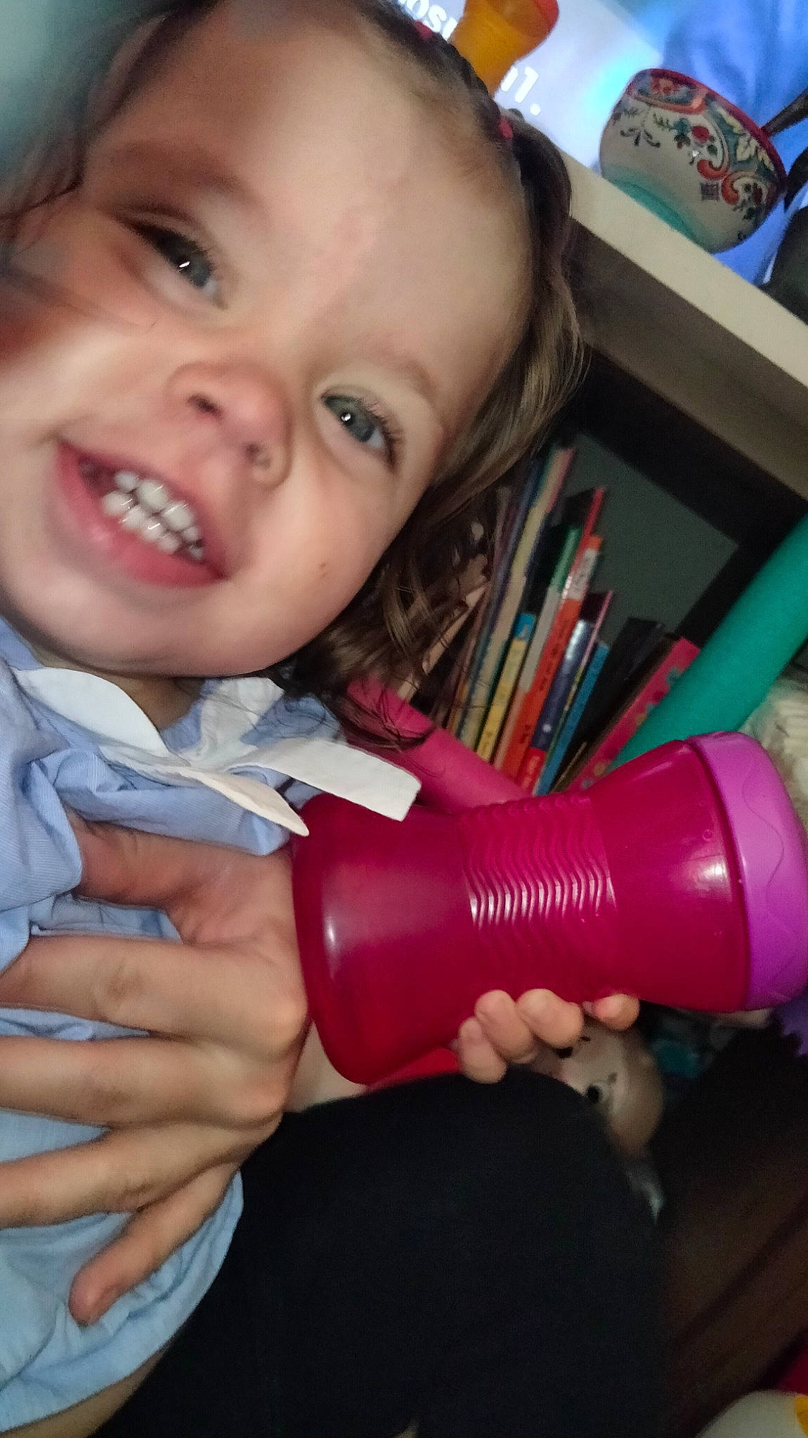 Athena is registered to the contest to win money with this photo: arm, cheek, drinkware, finger, hand, happy, human_body, iris, lip, mouth, nail, nose, organ, person, pink, plastic_bottle, product, skin, smile, thumb