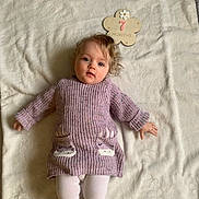 Lily joined the competition — help win amazing prizes! baby, blanket, child, cute, eyes, face, hands, indoor, infant, knitwear, lying_down, milestone, pink, portrait, seven_months, soft_texture, sweater, tights, white_background, wooden_sign