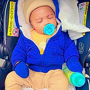 David Kaiden joined the competition — help win amazing prizes! baby, beige_clothes, blanket, blue_jacket, car_seat, cute, hat, hood, infant, mittens, newborn, pacifier, parent_hand, safety_label, seatbelt, sippy_bottle, sleeping, socks, soft_lining, striped_canopy