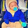 baby, beige_clothes, blanket, blue_jacket, car_seat, cute, hat, hood, infant, mittens, newborn, pacifier, parent_hand, safety_label, seatbelt, sippy_bottle, sleeping, socks, soft_lining, striped_canopy