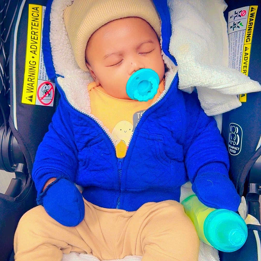 David Kaiden joined the competition — help win amazing prizes! baby, beige_clothes, blanket, blue_jacket, car_seat, cute, hat, hood, infant, mittens, newborn, pacifier, parent_hand, safety_label, seatbelt, sippy_bottle, sleeping, socks, soft_lining, striped_canopy