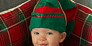 Harper joined the competition — help win amazing prizes! child, toddler, baby, elf_hat, christmas, holiday, plaid, seat, chair, fabric, portrait, face, eyes, ear, smile, cozy, indoor, festive, red_and_green, hat