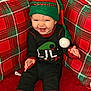 Harper is registered to the contest to win money with this photo: baby, child, infant, smiling, elf_hat, pom_pom, striped_socks, holiday, christmas, plaid_pillow, red, green, seated, laughing, cute, indoor, cushion, onesie, portrait, cozy