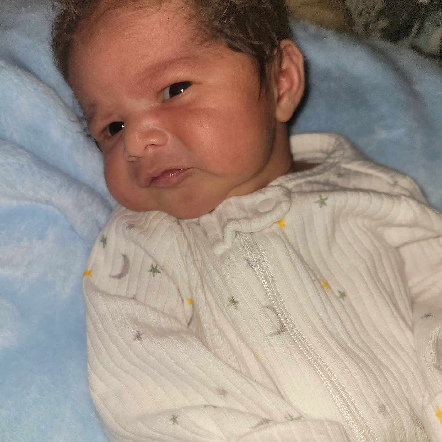 Adriel is registered to the contest to win money with this photo: baby, blue_blanket, child, closeup, cozy, cute, expression, face, hair, indoors, infant, newborn, onesie, portrait, resting, skin, sleepwear, soft_texture, white_clothing, young