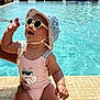 baby, child, sunglasses, hat, swimsuit, pool, water, sunny, vacation, smiling, happy, waving, outdoor, summer, tiled_edge, ocean, umbrella, people, background, sunlight