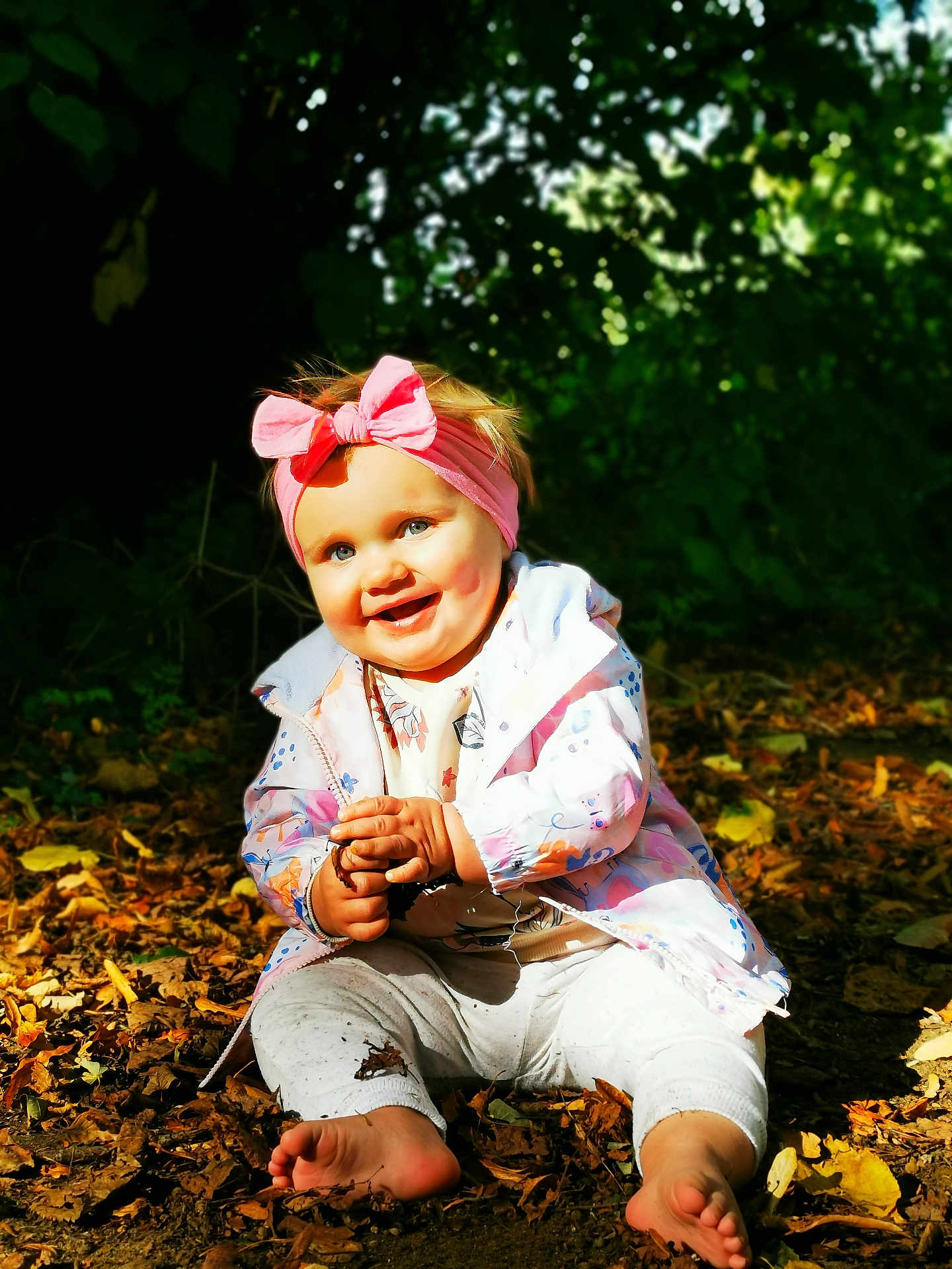 Molly joined the competition — help win amazing prizes! baby, child, smiling, outdoor, nature, autumn, leaves, headband, pink, jacket, barefoot, happy, sitting, forest, fall, cute, person, young, playful, sunlight