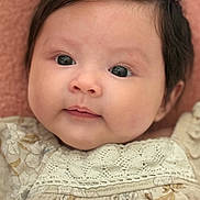 Naomi Luna is registered to the contest to win money with this photo: baby, infant, face, portrait, close_up, child, cute, hair, bow, clothing, fabric, texture, skin, eyes, expression, soft, pink_background, head, newborn, smile