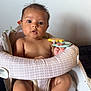 baby, baby_chair, background, blanket, child, comfort, curious, cushion, expression, face, foot, hand, holding, indoor, infant, pattern, seated, skin, toy, young