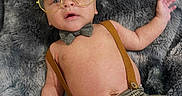 Musa joined the competition — help win amazing prizes! baby, blanket, bow_tie, child, cozy, cute, face, fashion, fur_texture, glasses, hand, hat, indoor, infant, lying_down, pants, pattern, plaid, portrait, suspenders