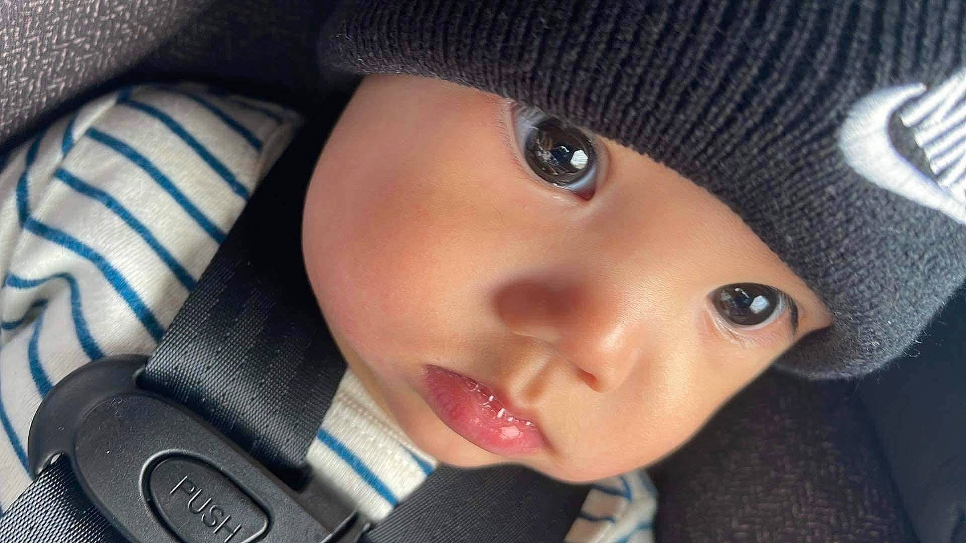 Santino is registered to the contest to win money with this photo: baby, black_hair, cap, cheek, child, chin, close_up, cool, electric_blue, eye, eyebrow, eyelash, forehead, head, headwear, iris, lip, nose, person, skin