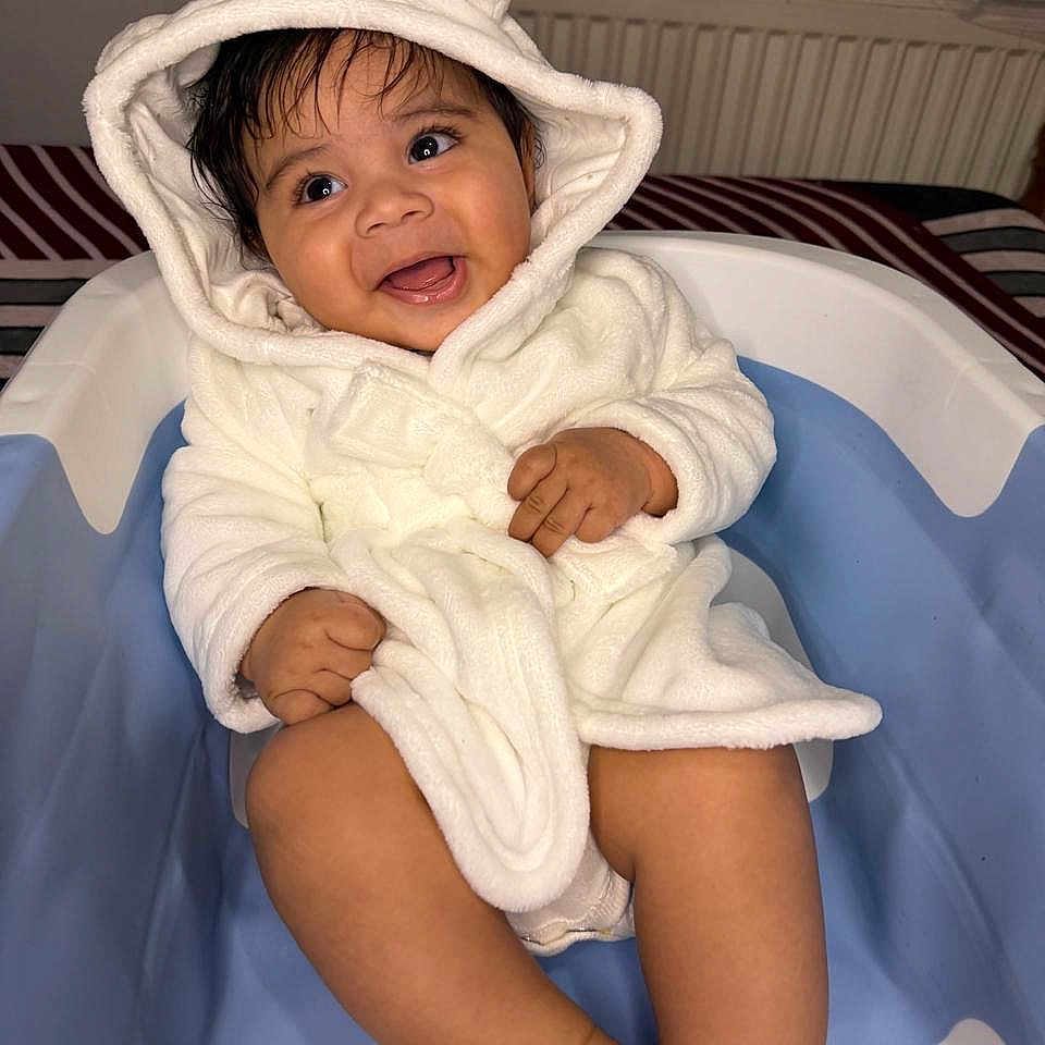Kridhav is registered to the contest to win money with this photo: baby, bathtub, child, clothing, comfort, cute, expression, hands, happy, hood, indoor, infant, legs, playful, portrait, sitting, skin, smile, warm, white_robe