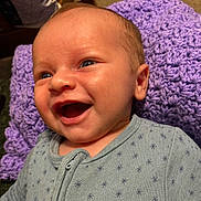 Perseus joined the competition — help win amazing prizes! baby, smiling, face, infant, blue_onesie, knitted_blanket, purple_blanket, happy, closeup, portrait, child, skin, eyes, mouth, cozy, indoor, cute, expression, newborn, resting