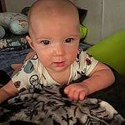 Carter joined the competition — help win amazing prizes! baby, child, face, blanket, pillow, indoor, person, infant, clothing, cute, pattern, hand, resting, soft, bedroom, portrait, young, looking, comfort, cozy