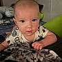 baby, child, face, blanket, pillow, indoor, person, infant, clothing, cute, pattern, hand, resting, soft, bedroom, portrait, young, looking, comfort, cozy