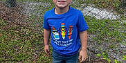 Ryder joined the competition — help win amazing prizes! blue_tshirt, boy, casual_clothing, child, daylight, expression, fence, front_view, grass, greenery, outdoor, person, playground, preschool, shorts, smile, sneakers, summer, trees, young_child
