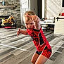 Ryder is registered to the contest to win money with this photo: barefoot, boy, carpet, child, expression, furniture, home_decor, indoor, living_room, person, playful, pose, red_clothing, rocking_horse, sign, spiderman, superhero_costume, toy, wood_floor, wood_panel_wall