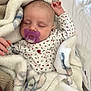 baby, sleeping, blanket, pacifier, infant, cozy, soft, cute, child, onesie, patterned_clothing, rest, peaceful, indoor, comfort, closeup, face, hand, nap, warm