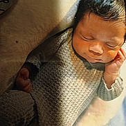 Jasiah joined the competition — help win amazing prizes! baby, sleeping, knitted_outfit, cozy, infant, hand, face, blanket, soft_light, newborn, peaceful, cute, portrait, resting, child, indoors, warm, comfort, small, relaxing