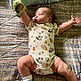Ezekiel is registered to the contest to win money with this photo: baby, infant, bed, blanket, toy, onesie, animal_print, sock, patterned, sleeping_area, child, person, cute, small, lying_down, furniture, indoors, skin, hand, foot