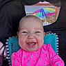 baby, smiling, child, stroller, pink_clothing, flamingo_pattern, blue_eyes, tooth, mesh_window, beach_umbrella, outdoor, happy, infant, seat, sunlight, portrait, cute, person, baby_clothes, colorful