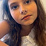 Léna a rejoint le concours — aidez-le/la à gagner de superbes lots ! child, girl, portrait, face, expression, long_hair, white_top, close_up, indoor, young, person, human, skin, eyelashes, eyes, hair, shoulder, casual, soft_light, blurred_background