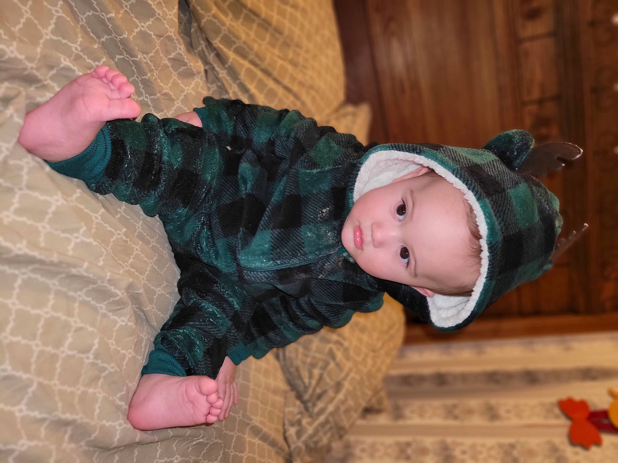 Kaleb is registered to the contest to win money with this photo: baby, baby_toddler_clothing, cheek, child, comfort, face, flooring, foot, fun, hat, human_leg, pattern, person, pink, sitting, skin, sleeve, sock, toddler, tree