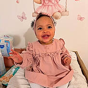 Ayanna participe au concours pour gagner de l'argent avec cette photo : baby, child, smiling, pink_dress, headband, toddler, indoor, changing_table, towel, baby_products, wall_art, teddy_bear, butterfly, heart, curly_hair, happy, cute, portrait, infant, person