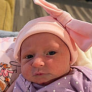 Mia joined the competition — help win amazing prizes! baby, infant, pink_hat, bow, purple_clothing, polka_dot, face, indoor, portrait, cute, newborn, child, soft_lighting, closeup, person, headwear, apparel, human, looking, expression