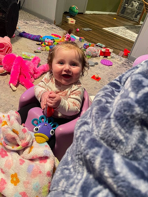 Bailey joined the competition — help win amazing prizes! baby, cheek, child, event, flooring, fun, happy, head, iris, joy, leisure, linens, person, pink, purple, room, sharing, sitting, skin, smile