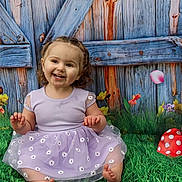 Artemis joined the competition — help win amazing prizes! toddler, child, smiling, purple_dress, grass, flowers, wooden_fence, basket, easter_eggs, mushroom, greenery, outdoor, cute, happy, sitting, portrait, nature, playful, spring, colorful