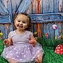 toddler, child, smiling, purple_dress, grass, flowers, wooden_fence, basket, easter_eggs, mushroom, greenery, outdoor, cute, happy, sitting, portrait, nature, playful, spring, colorful