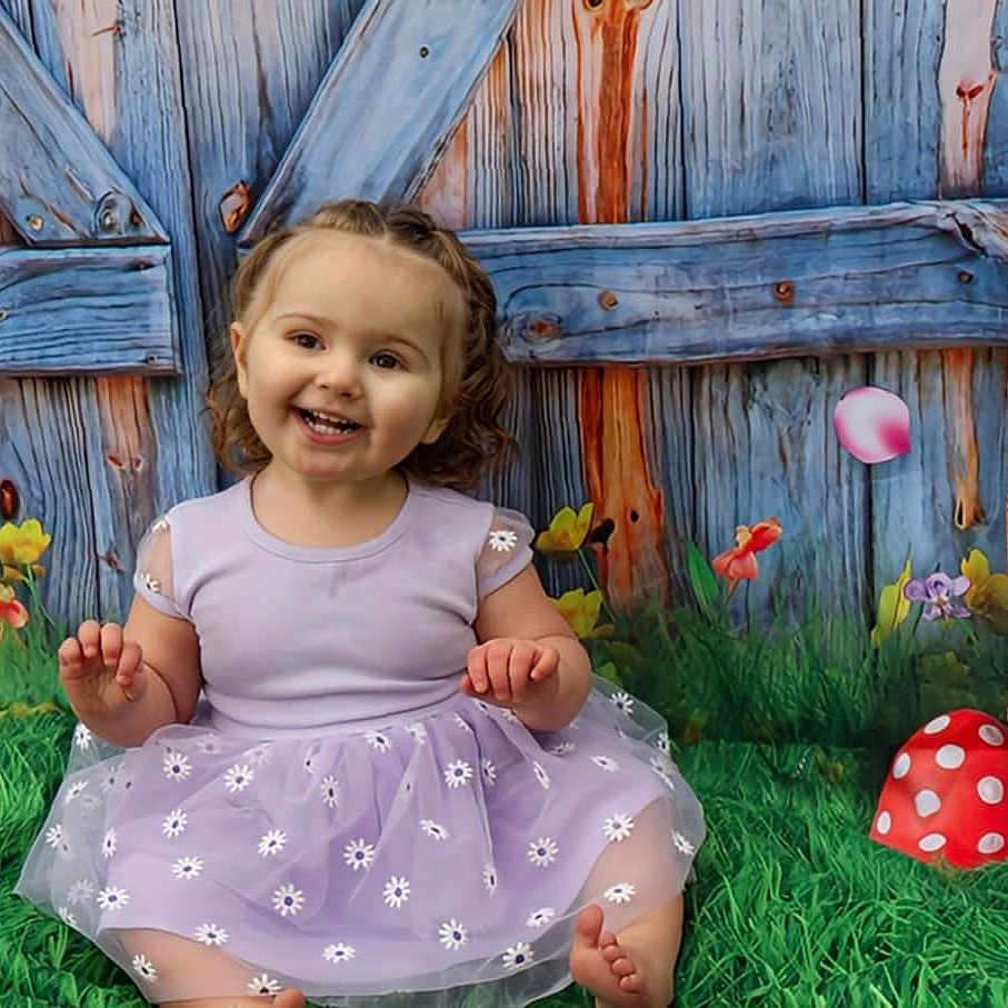 Artemis joined the competition — help win amazing prizes! basket, child, colorful, cute, easter_eggs, flowers, grass, greenery, happy, mushroom, nature, outdoor, playful, portrait, purple_dress, sitting, smiling, spring, toddler, wooden_fence