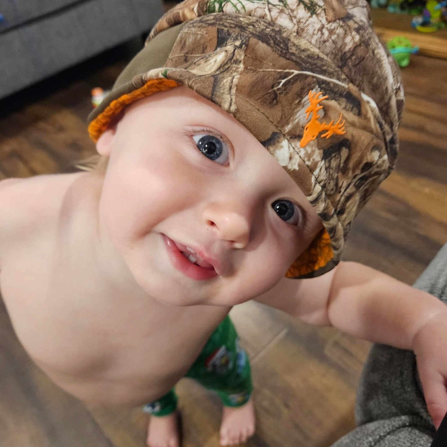 Finnegan joined the competition — help win amazing prizes! architecture, baby, baseballcap, building, cap, clothing, couch, crawling, face, furniture, happy, hardwood, hat, head, pants, person, photography, portrait, smile, wood