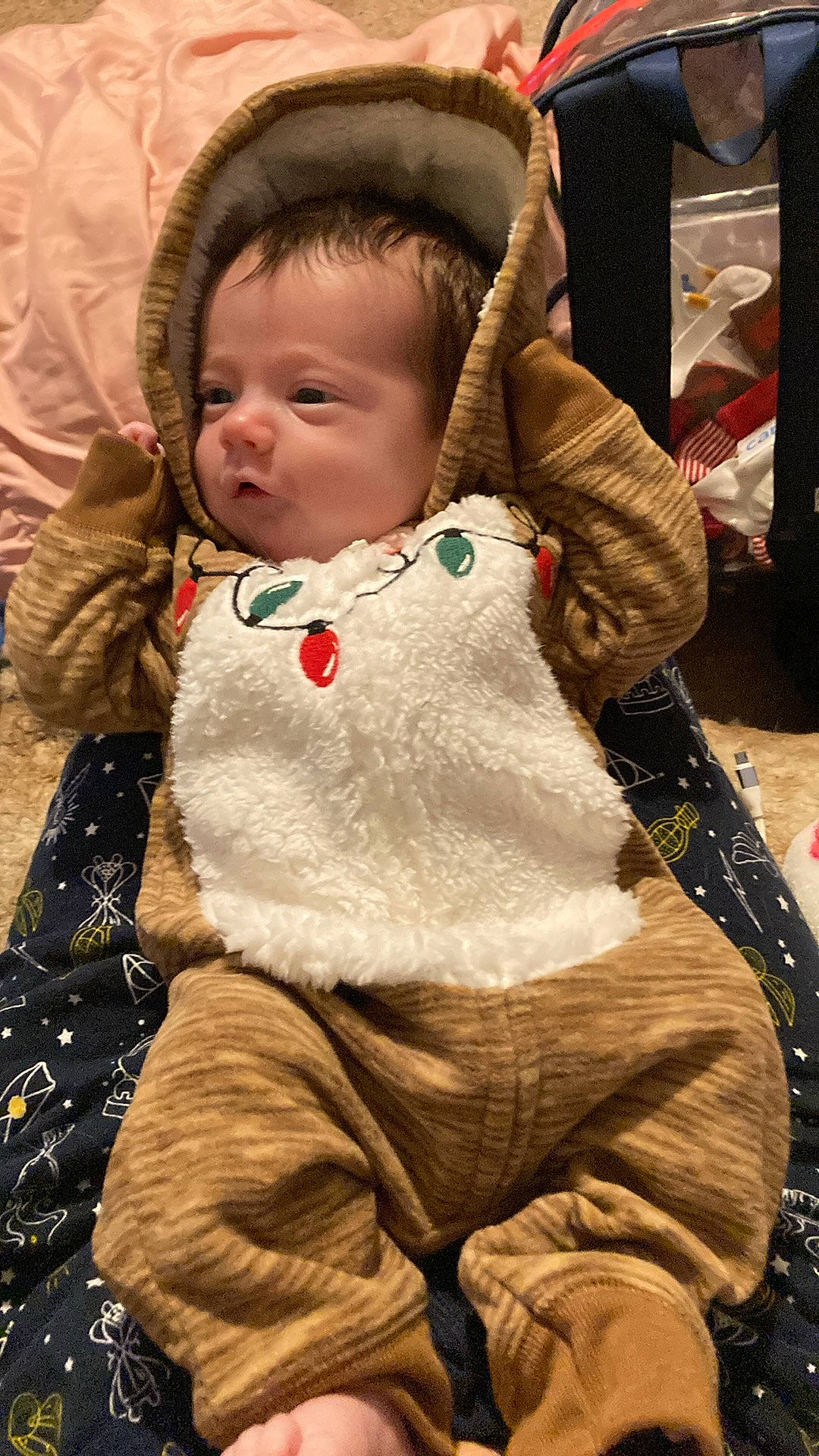 baby, bed, blanket, bonnet, clothing, coat, cushion, face, furniture, hat, head, homedecor, hood, jacket, newborn, pants, person, photography, portrait, quilt