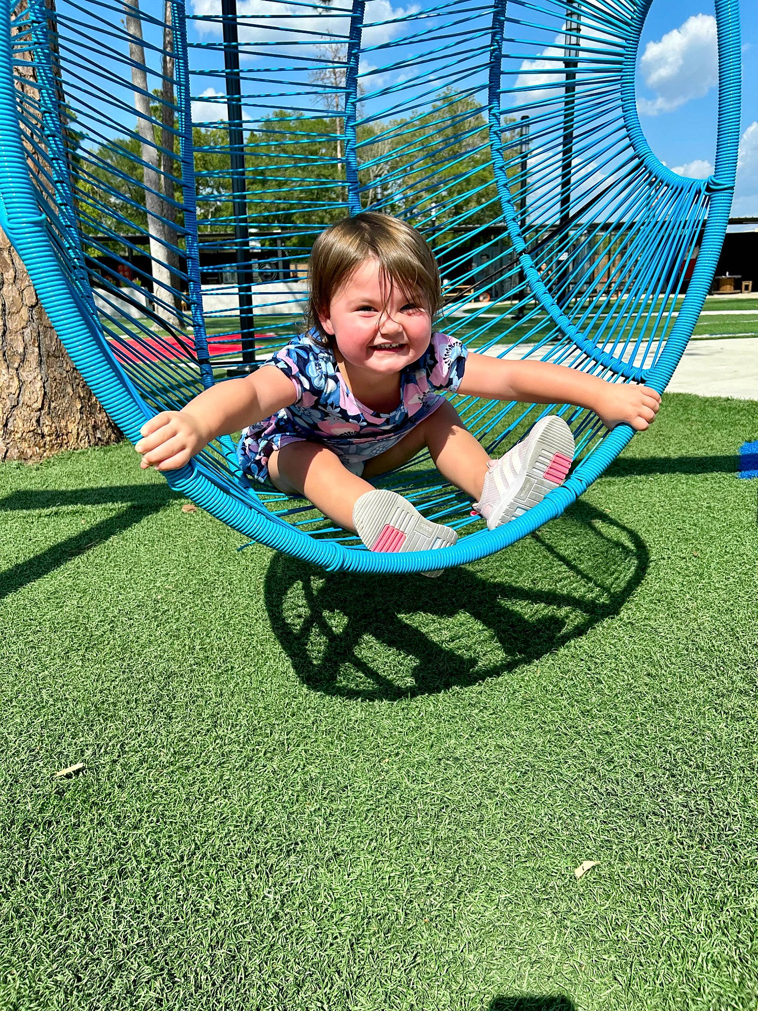 Aspen is registered to the contest to win money with this photo: baby, child, chute, city, electric_blue, fun, grass, joy, leisure, nonbuilding_structure, outdoor_play_equipment, people_in_nature, person, plant, play, playground, recreation, sitting, smile, swing