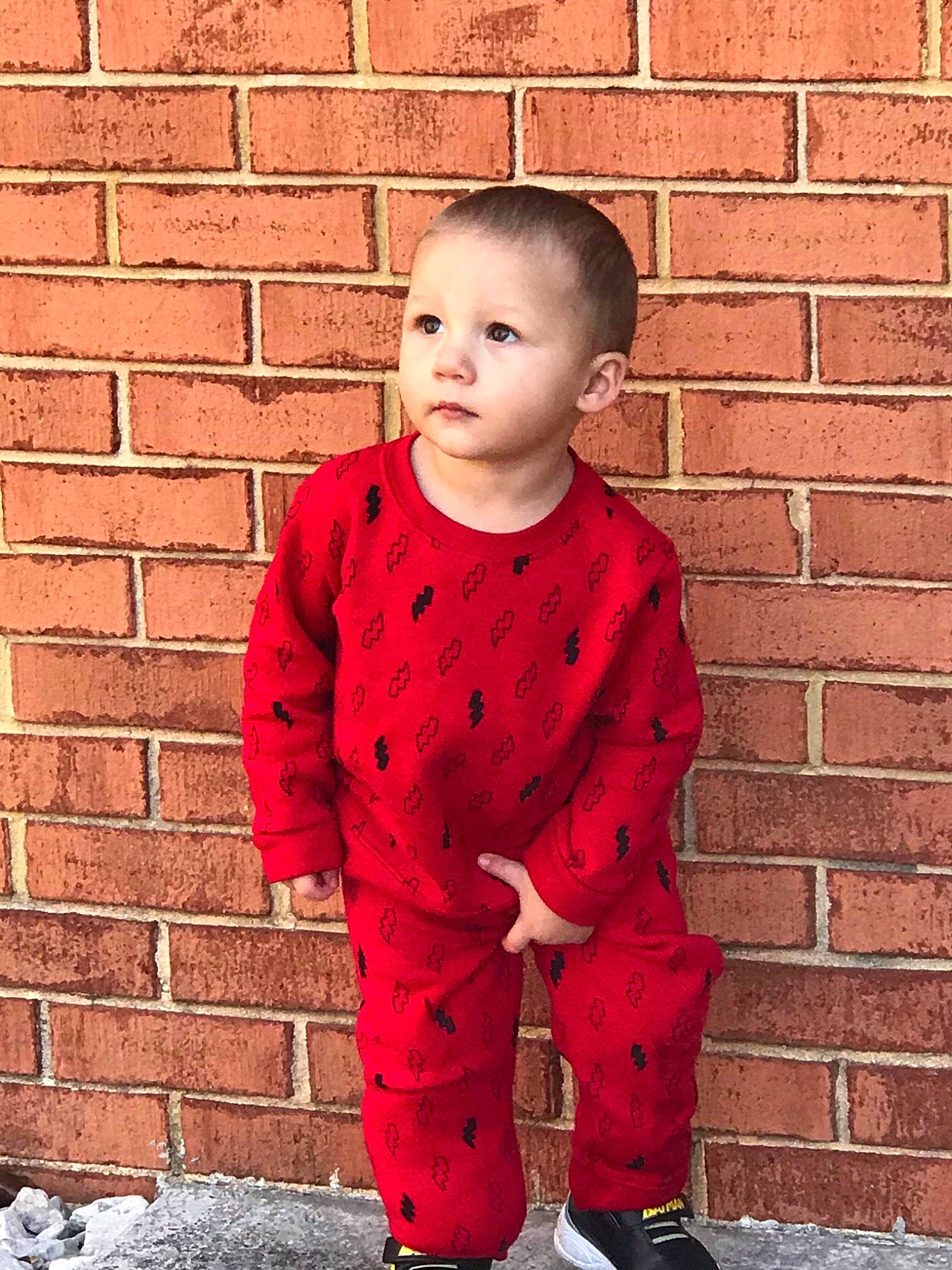 Colby joined the competition — help win amazing prizes! brick, brickwork, child, child_model, jacket, male, outerwear, pattern, person, red, sleeve, standing, toddler, wall