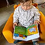 book, boy, child, face, head, male, openingpresent, person, publication, reading, sitting