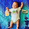 Evan is registered to the contest to win money with this photo: baby, blue, camping, child, cute, decor, face, green, indoor, infant, lantern, lying_down, onesie, person, plush, portrait, quilt, sign, soft_lighting, two_months