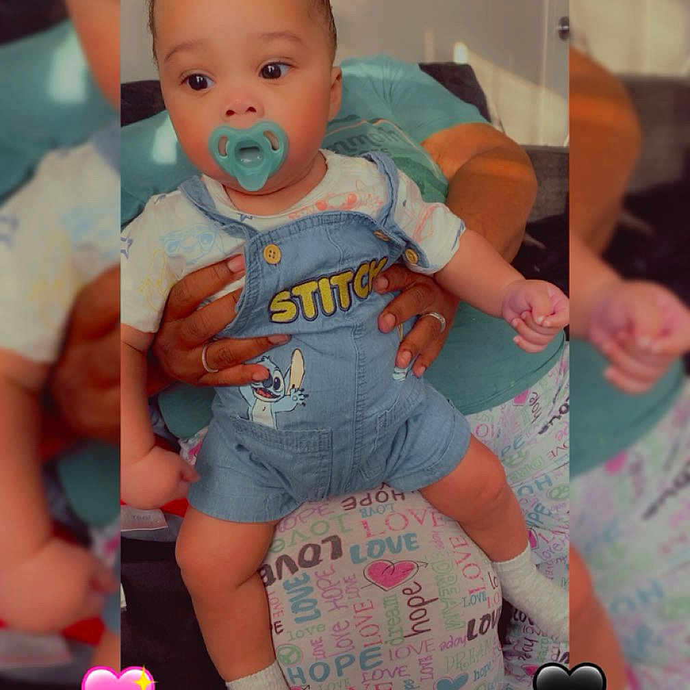 Kyce joined the competition — help win amazing prizes! baby, child, clothing, colorful, cushion, cute, denim_overalls, family, hands, heart_emojis, hope, indoor, infant, love, pacifier, person, portrait, sitting, stitch, text_pattern