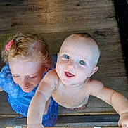 Miles joined the competition — help win amazing prizes! baby, child, girl, blue_eyes, curly_hair, smiling, happy, wooden_floor, bare_chest, diaper, blue_dress, freckles, hand, looking_up, looking_down, indoor, natural_light, playful, siblings, cute