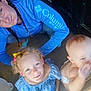 woman, child, baby, braids, blue_shirt, curly_hair, smile, indoor, wooden_floor, door, diaper, playful, freckles, looking_up, family, casual_clothing, light, person, happy, candid