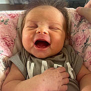 Sadie is registered to the contest to win money with this photo: baby, infant, smiling, happy, face, hand, blanket, clothing, hair, portrait, closeup, cute, cozy, indoors, person, newborn, expression, skin, pink, toddler