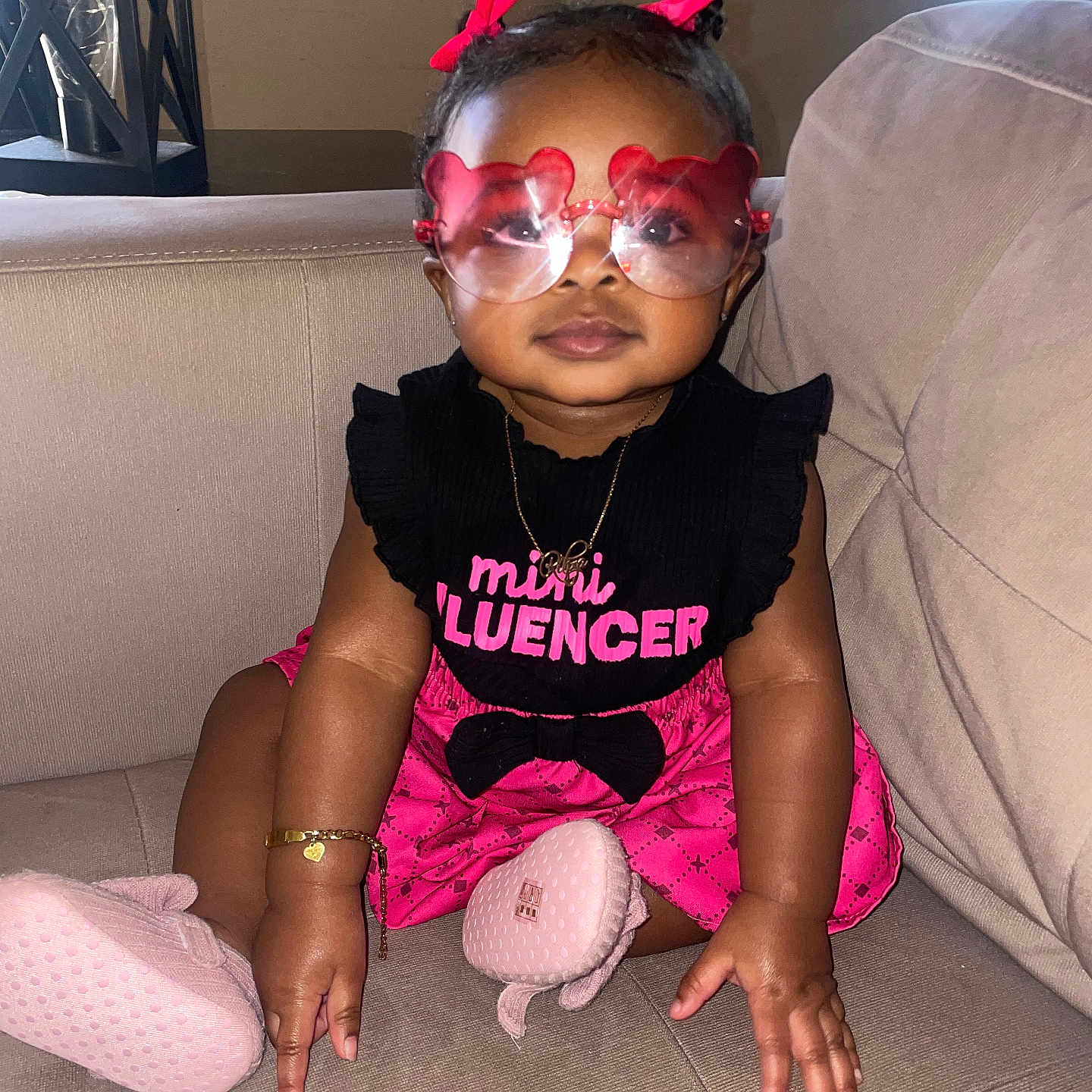 Rihza R. Williams is registered to the contest to win money with this photo: accessories, baby, clothing, couch, cushion, face, furniture, glasses, head, homedecor, hosiery, jewelry, necklace, person, photography, portrait, purple, sitting, sunglasses, t_shirt