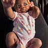baby, infant, child, onesie, headband, orange, pink, hello_kitty, hand, feet, soft_slippers, cute, curious, lying_down, portrait, indoors, skin, person, apparel, expression