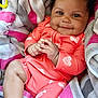 Za'Karrah is registered to the contest to win money with this photo: baby, smiling, infant, pink_clothing, hearts, towel, cozy, happy, cute, portrait, child, skin, face, hands, leg, curly_hair, indoors, soft_texture, closeup, playful
