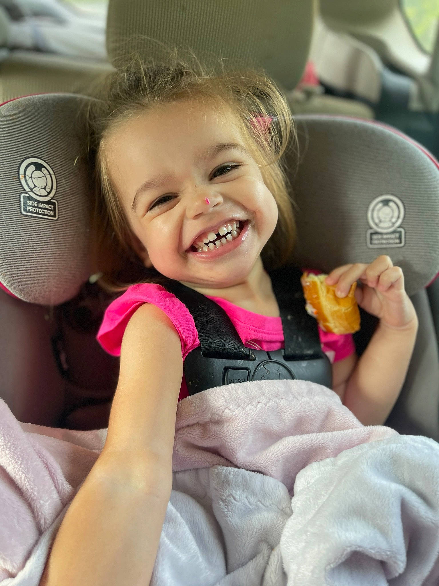 Evelynn is registered to the contest to win money with this photo: baby_in_car_seat, car, car_seat, car_seat_cover, child, comfort, face, facial_expression, finger, gesture, happy, head, joy, motor_vehicle, person, pink, skin, smile, steering_wheel, toddler