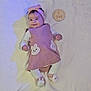 baby, infant, girl, pink_dress, headband, bunny, slippers, lying_down, blanket, wooden_plaque, milestone, cute, smiling, indoor, soft_lighting, child, portrait, adorable, clothing, baby_accessories