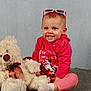 Shelby participe au concours pour gagner de l'argent avec cette photo : toddler, child, smiling, pink_clothing, sunglasses, teddy_bear, plush_toy, carpet, studio, portrait, happy, cute, sitting, indoor, baby, person, headwear, toy, casual, background